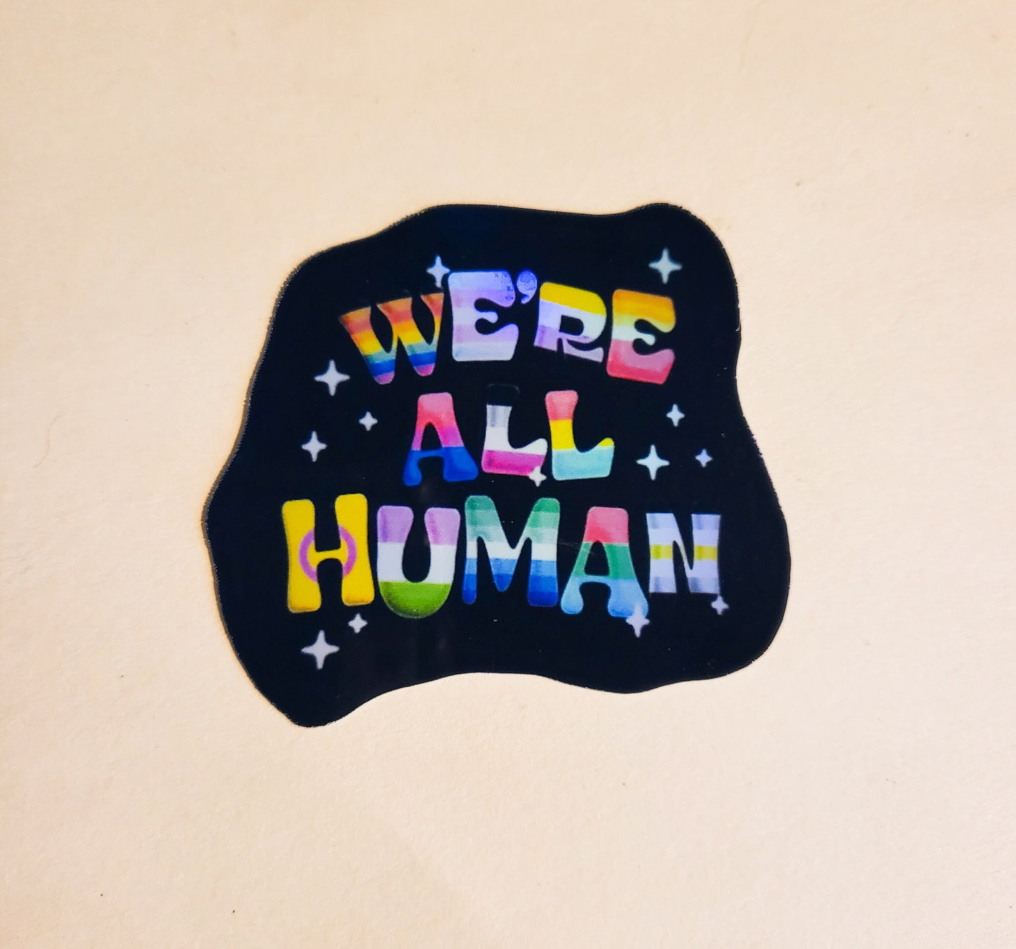 We're All Human Sticker - Holographic 2.3" x 2.2" - stickers decal lgbtqia+ lgbt pride flag rainbow flags gay lesbian bisexual trans