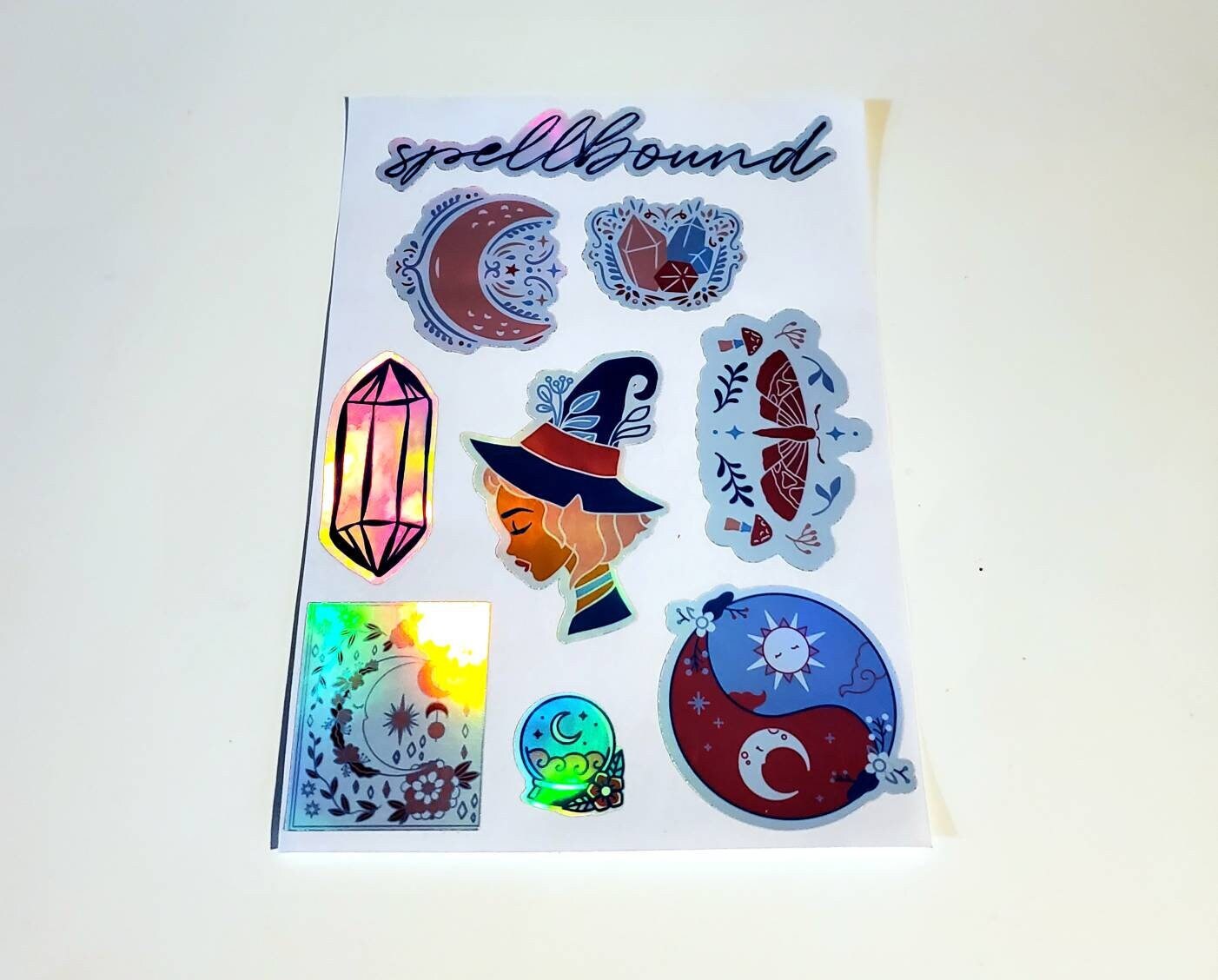 Holographic Spellbound Sticker Sheet - Waterproof 4.25" x 7.25" - witch magic moon crystals moth mushrooms sun Luna celestial